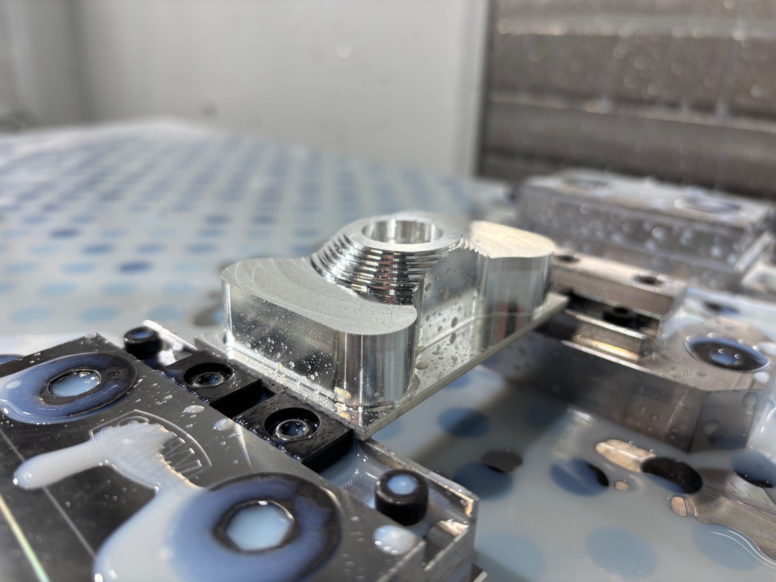 A finished, deburred Cambian-machined part on the fixture plate